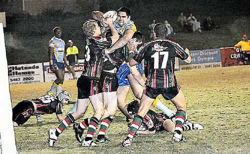 Gympie Devils player Kurt Fleming is wrapped up in Nambour’s defence launching an assault on the try line. The Devils play the Noosa Pirates today and hope to build their lead at the top of the competition ladder. Gympie Devils player Kurt Fleming is wrapped up in Nambour’s defence launching an assault on the try line. The Devils play the Noosa Pirates today and hope to build their lead at the top of the competition ladder.
